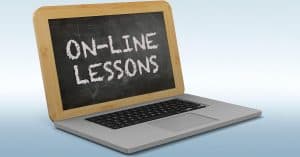 Laptop with a chalkboard instead of a screen. "On-Line Lessons" is written on the chalkboard.