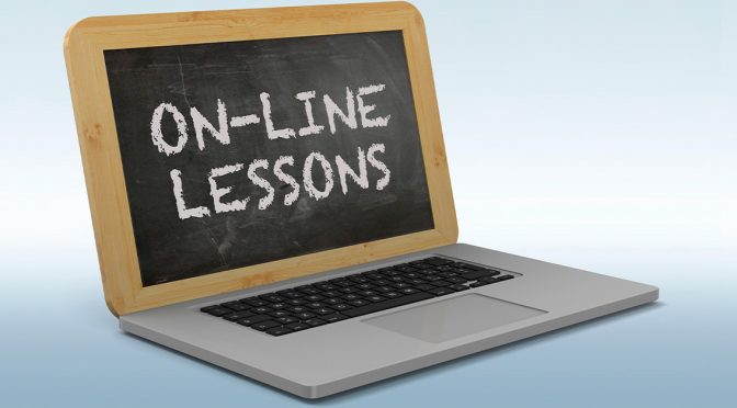 Laptop with a chalkboard instead of a screen. "On-Line Lessons" is written on the chalkboard.